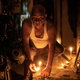Others lit a candle on the pavement in New Delhi.